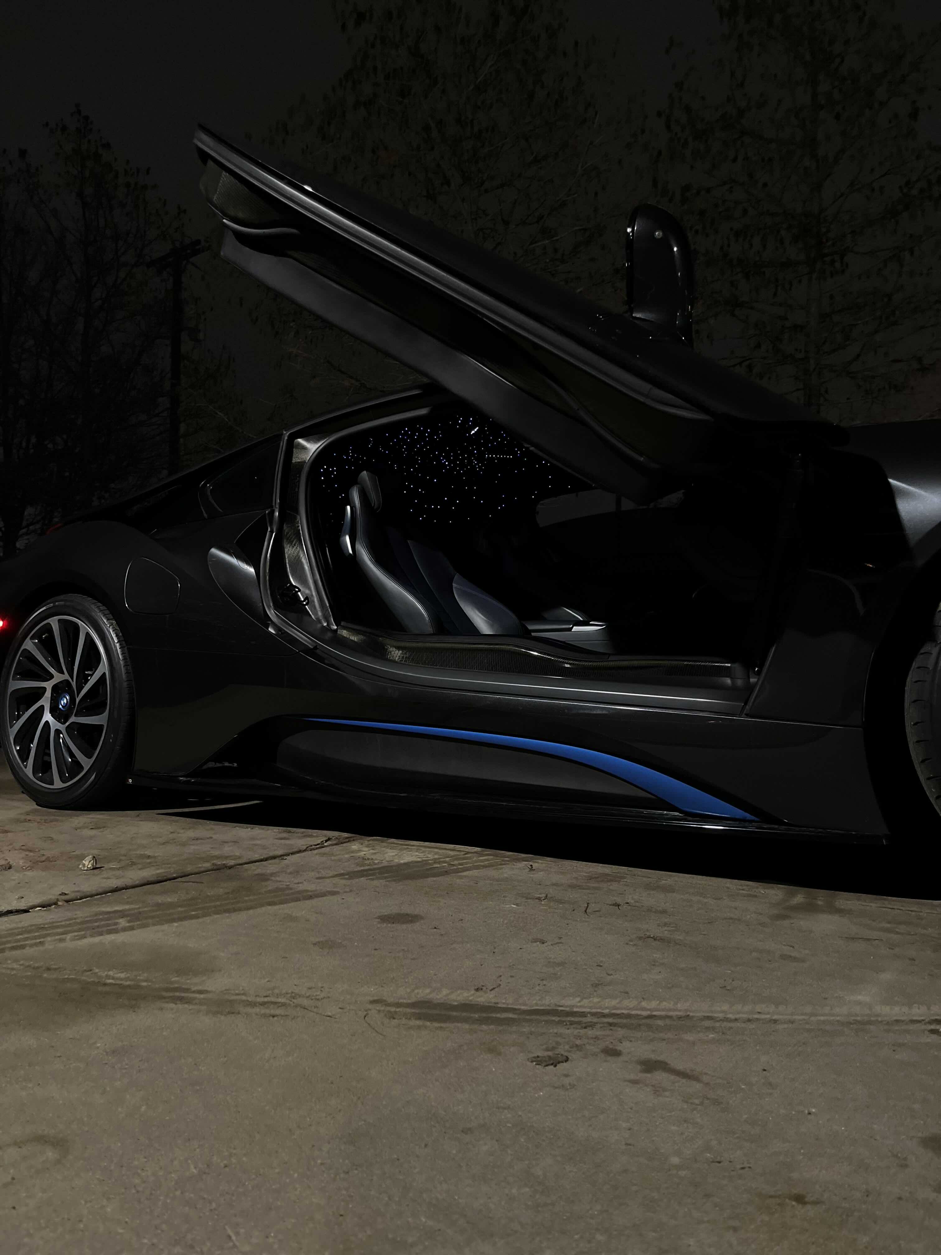 a black sports car with its doors open