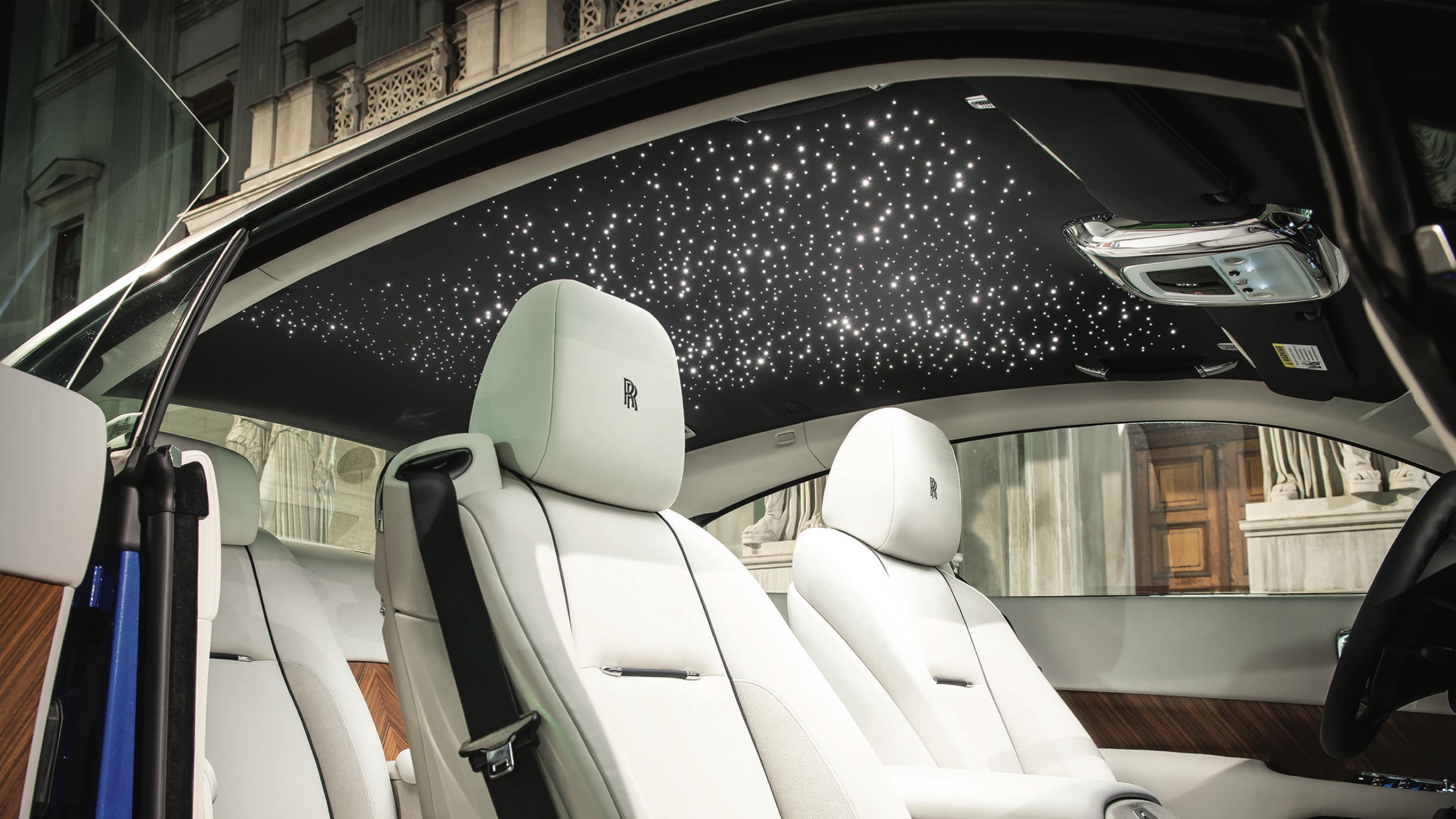 the interior of a car with white seats