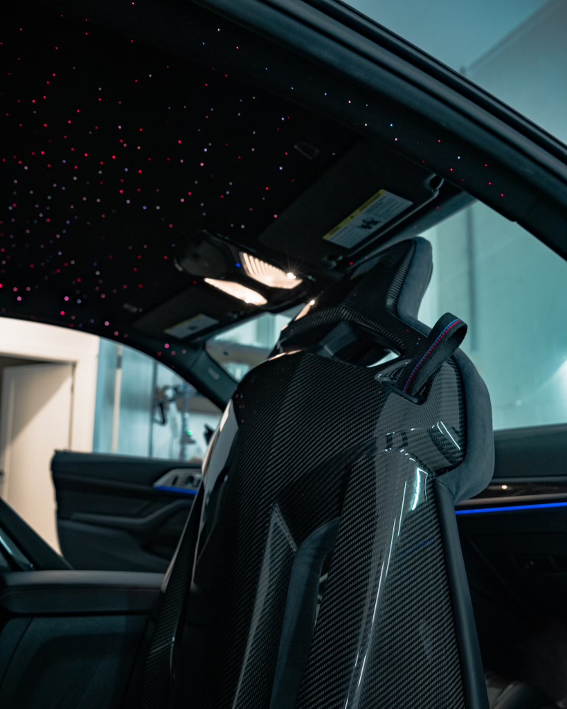 a black and grey car interior with a black and red dotted ceiling