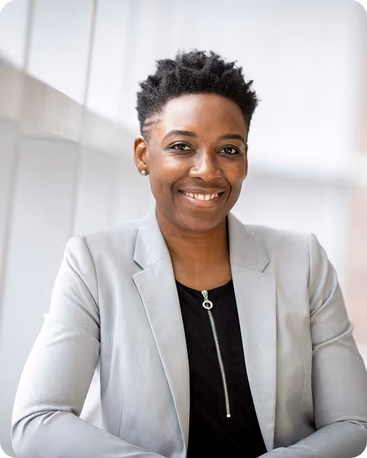 Black woman smiling with grey suit