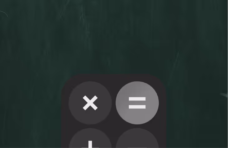 Close-up of a calculator or phone screen showing multiplication and equals buttons on a dark background.