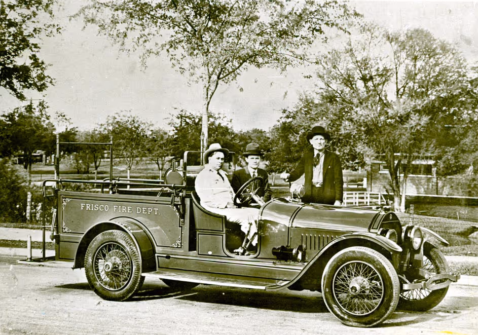 Vintage photo of early Frisco firefighters with historic fire truck marked "Frisco Fire Dept"