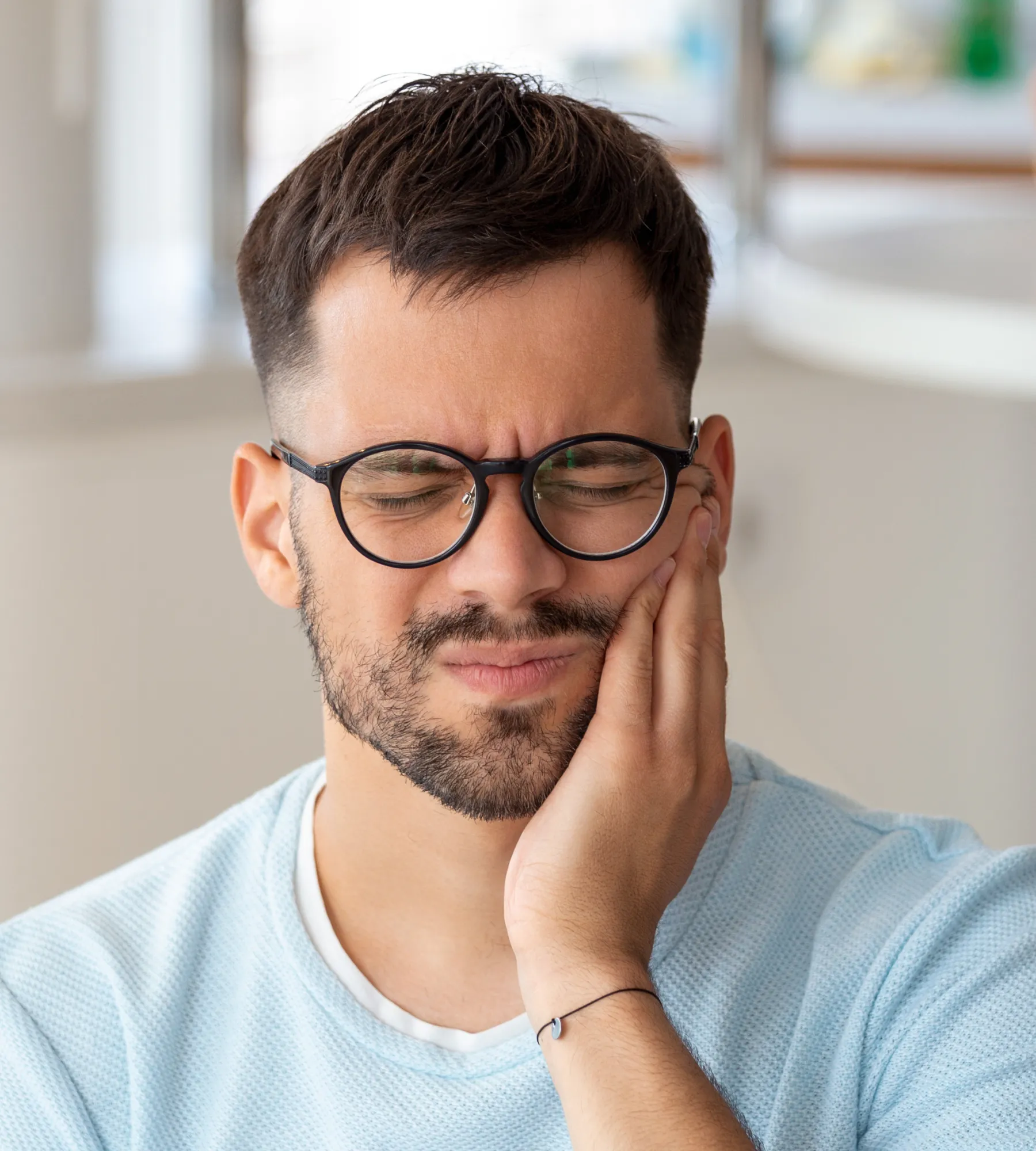 A man with glasses is looking at the camera.
