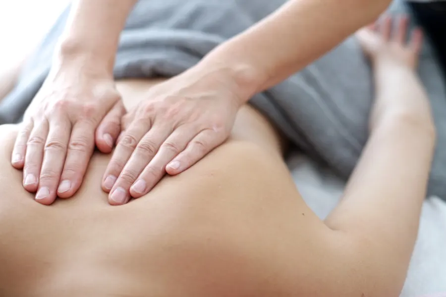 Massage therapist treating muscle tension