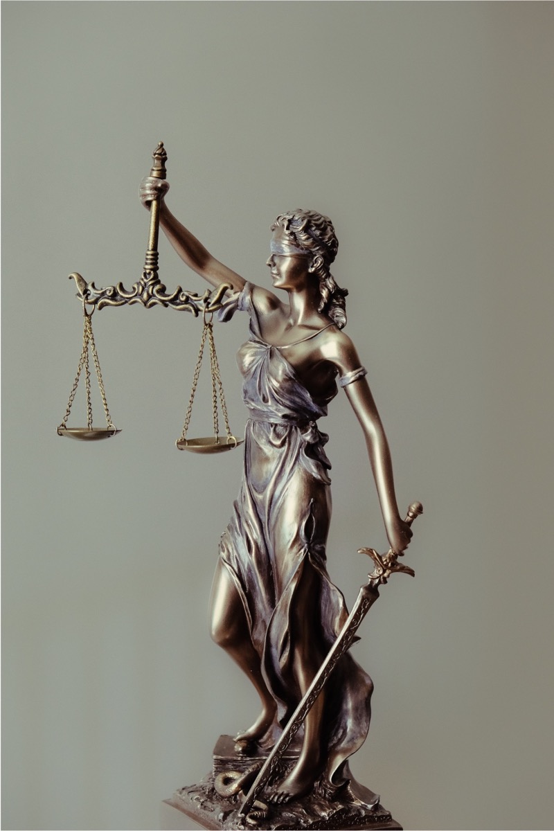 A statue of a women holding a balance and a sword, representing the law