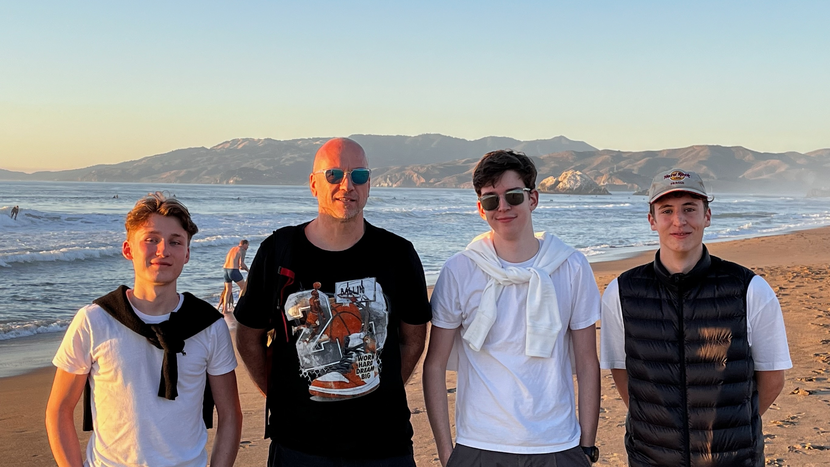 Photo of the three founders standing together in Golden Gate Park, San Francisco, smiling and posing outdoors