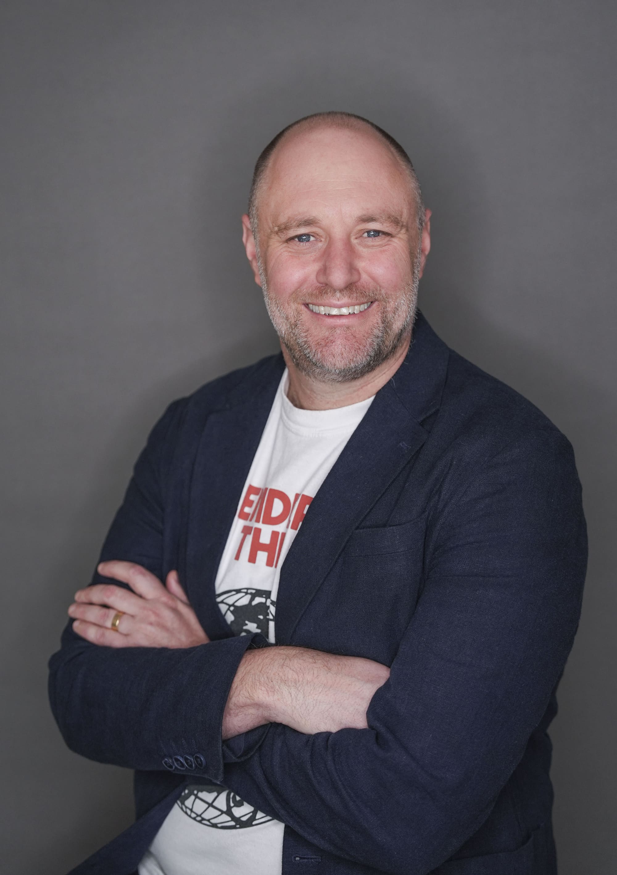 A profile image of The AI Training Company founder Shaun Davies sitting with his arms folded and looking at the camera. 