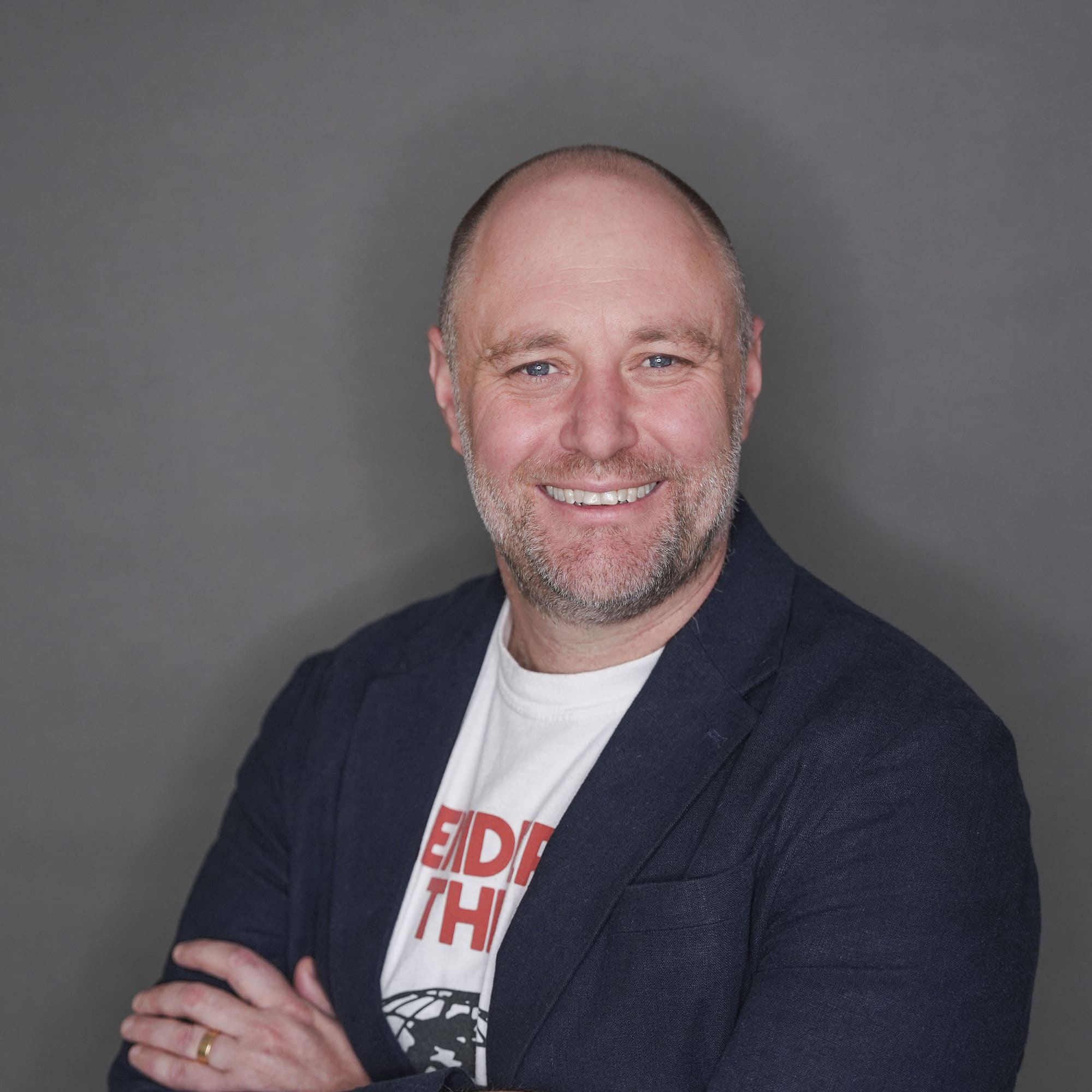 Image of The AI Training Company's founder Shaun Davies. He is looking at the camera and has his arms folded. 