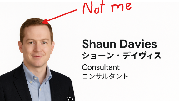 Shows a presentation slide with a man's head and the words Shaun Davies in English and Japanese. Above this in red scrawly text is written "Not Me", with an arrow pointing at the face. 