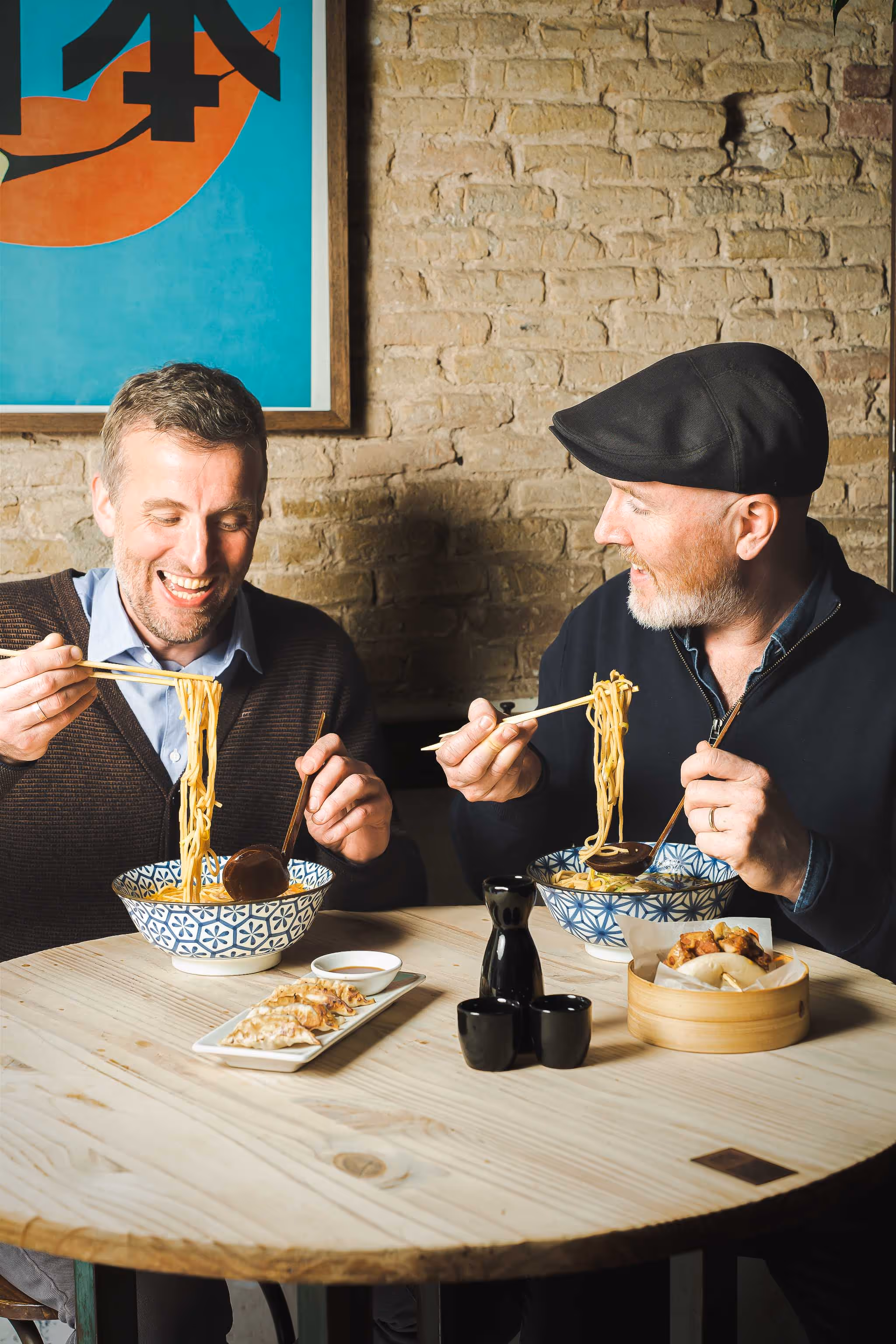 the owners (ross and mark) enjoying their ramen bowl and having a good time