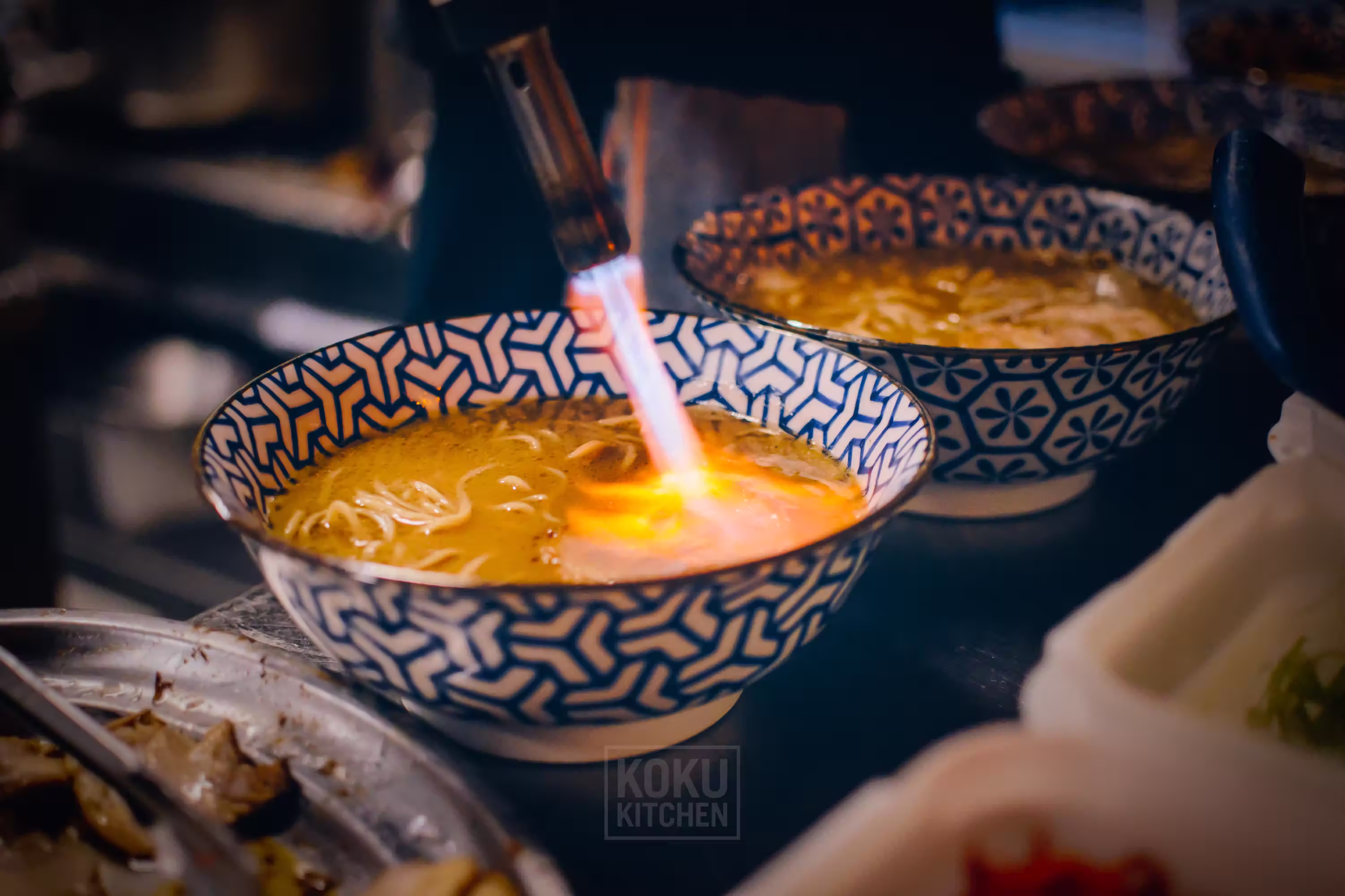 falmbe process of pork meat in a ramen bowl