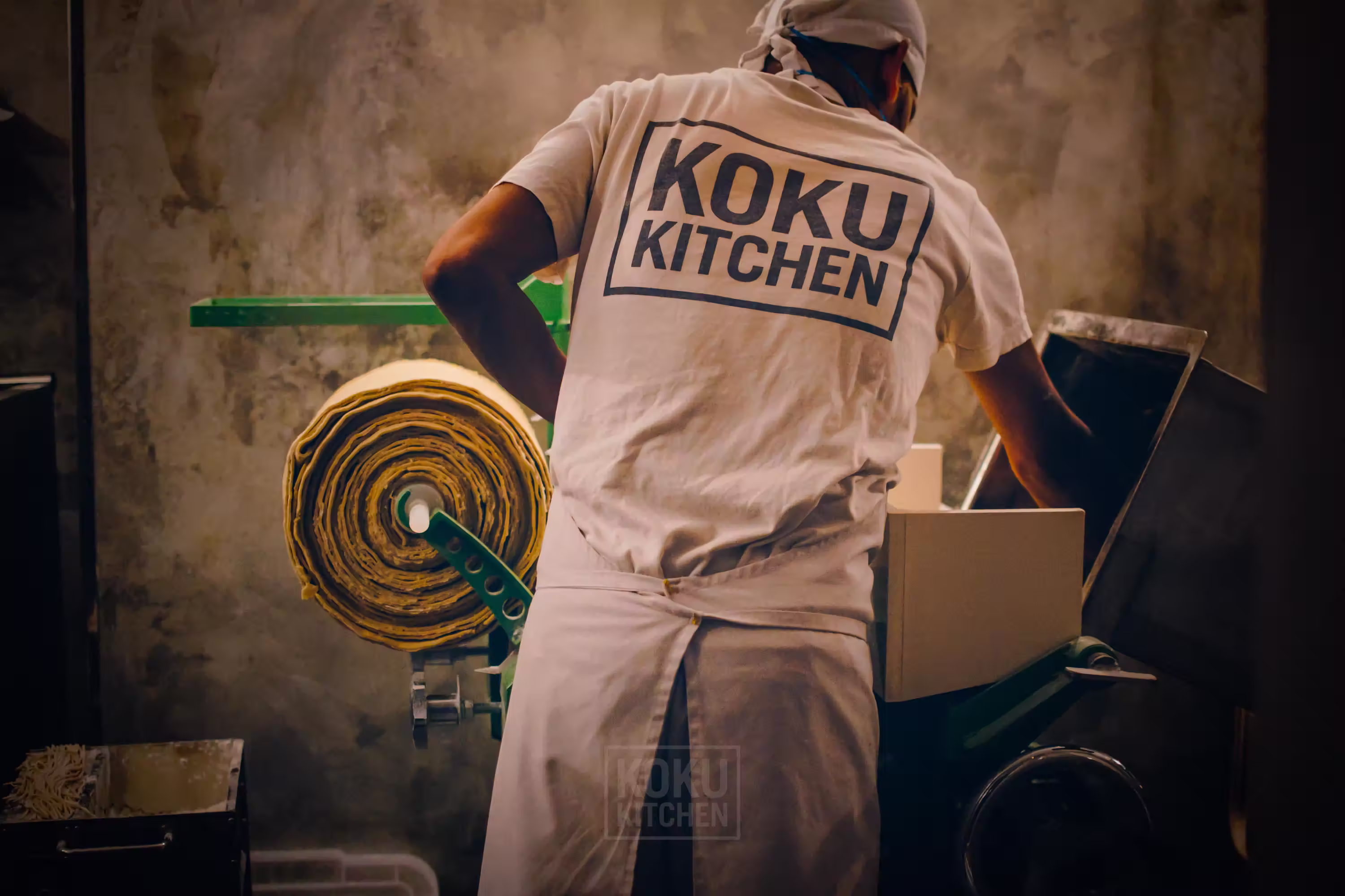 kitchen assistant preparing the noodles