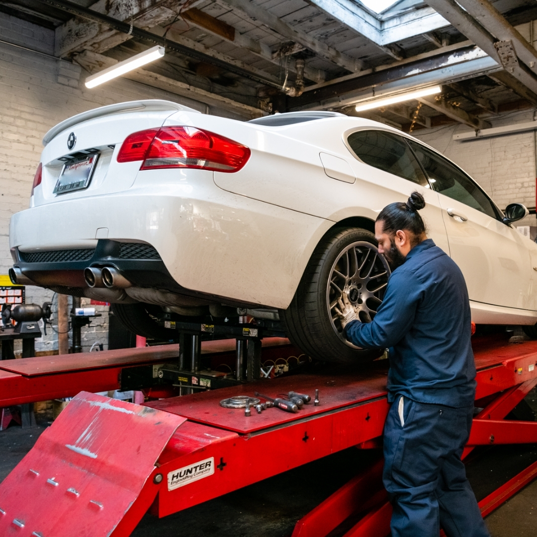 Auto repair technician inspecting vehicle at Faxon Garage
