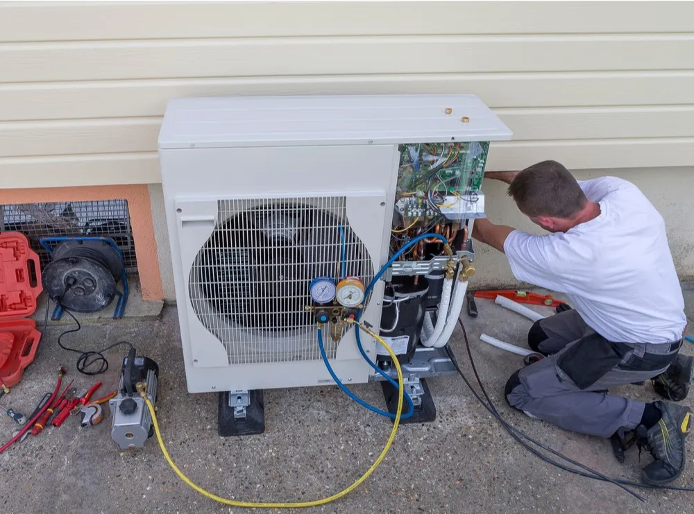 Technician servicing a heat pump.