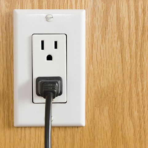 New electrical receptacle outlet with a plugged-in power cord, showcasing modern electrical upgrades for residential services in Minneapolis, MN.