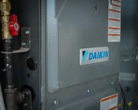 Daikin furnace unit showcasing installation details, featuring brand logo, service valves, and informational labels, relevant to HVAC services by Stafford Home Service in Minneapolis.