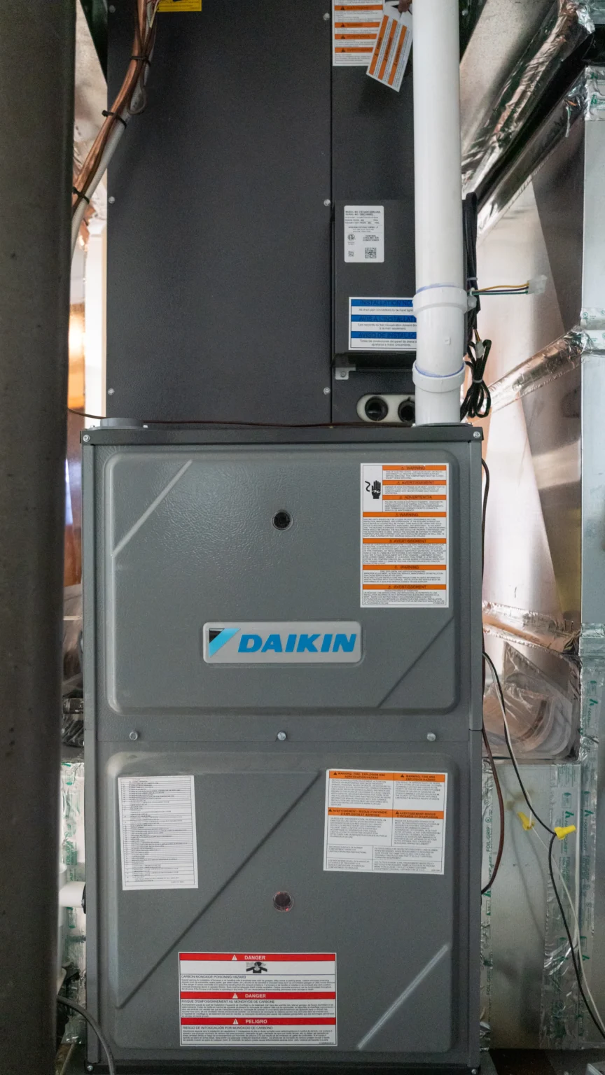 Daikin furnace unit in a residential setting, showcasing labels and safety instructions, highlighting HVAC repair services in Minneapolis, MN.