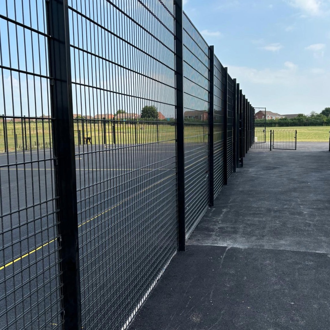 Security fencing installed with sports pitch visible in background