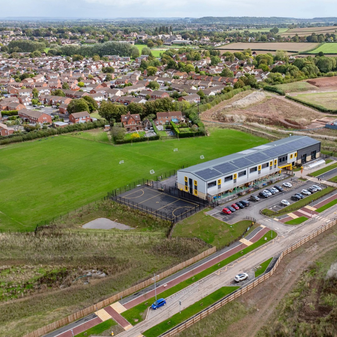 Ariel view of Orchard Grove Primary School with sports fields and fencing visible