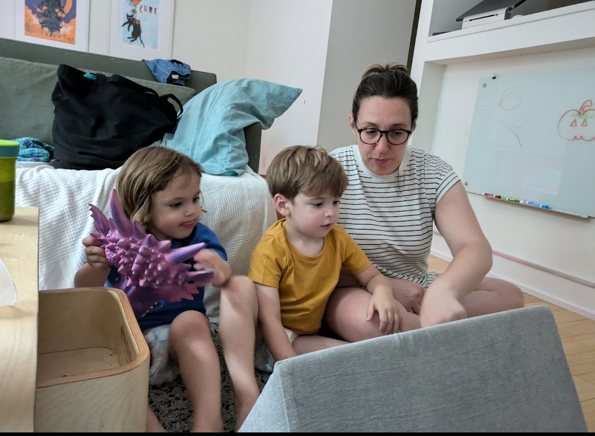 Parent and two children exploring sensory bin activity at home demonstrating tactile processing and engagement