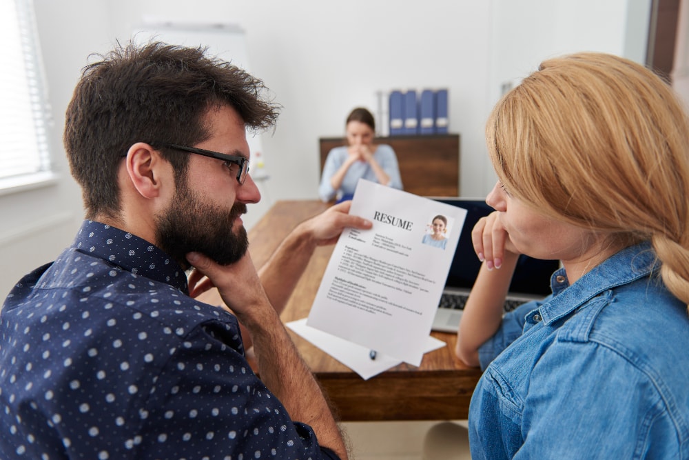 Employers reviewing the resume of a job applicant.