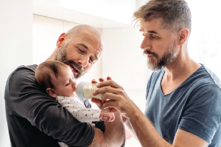 A couple takes care of an infant