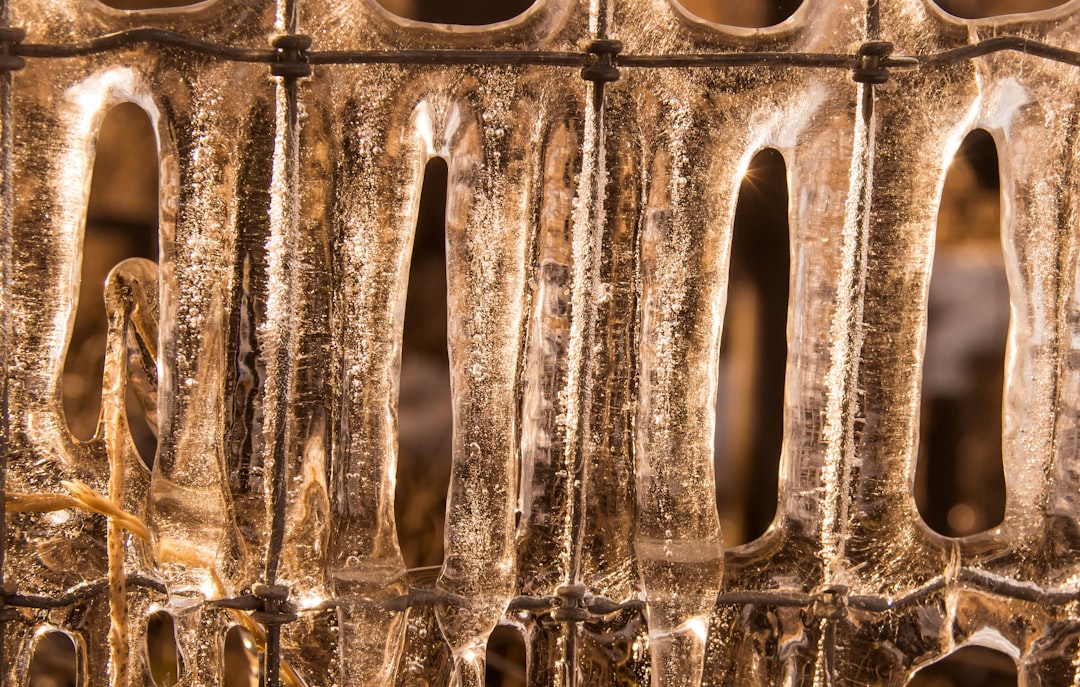 A close-up image of a frozen evaporator coil inside an AC unit - AC blowing warm air