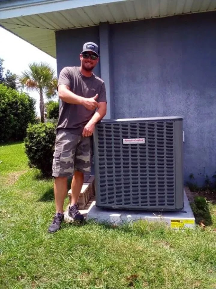 Homeowner reviewing an AC maintenance checklist next to a well-kept air conditioning unit