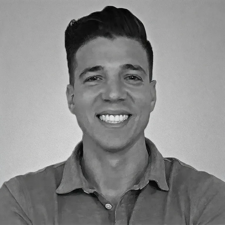 Black-and-white portrait of a smiling man in a collared shirt.