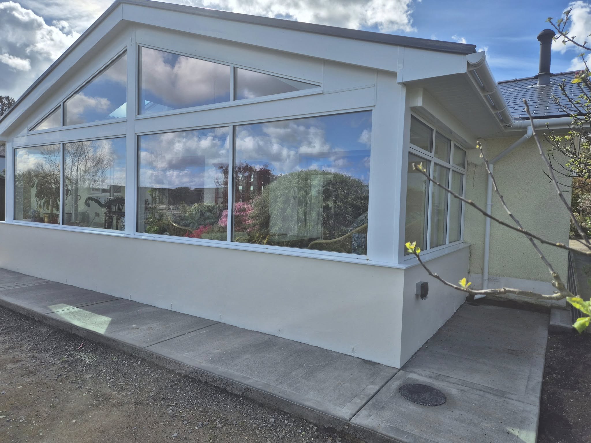 Sunroom with open double doors, patio outside.