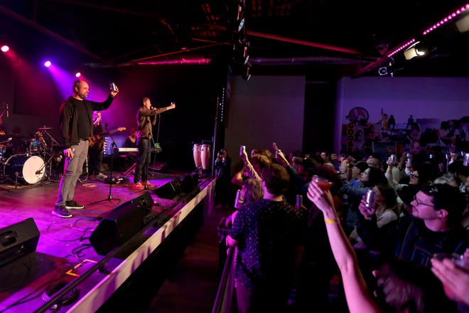 Stephen Tyler, left, and Chad Whitehead raise their beers for a toast during the first concert at Beer City Music Hall in Oklahoma City Thursday, March 31, 2022.