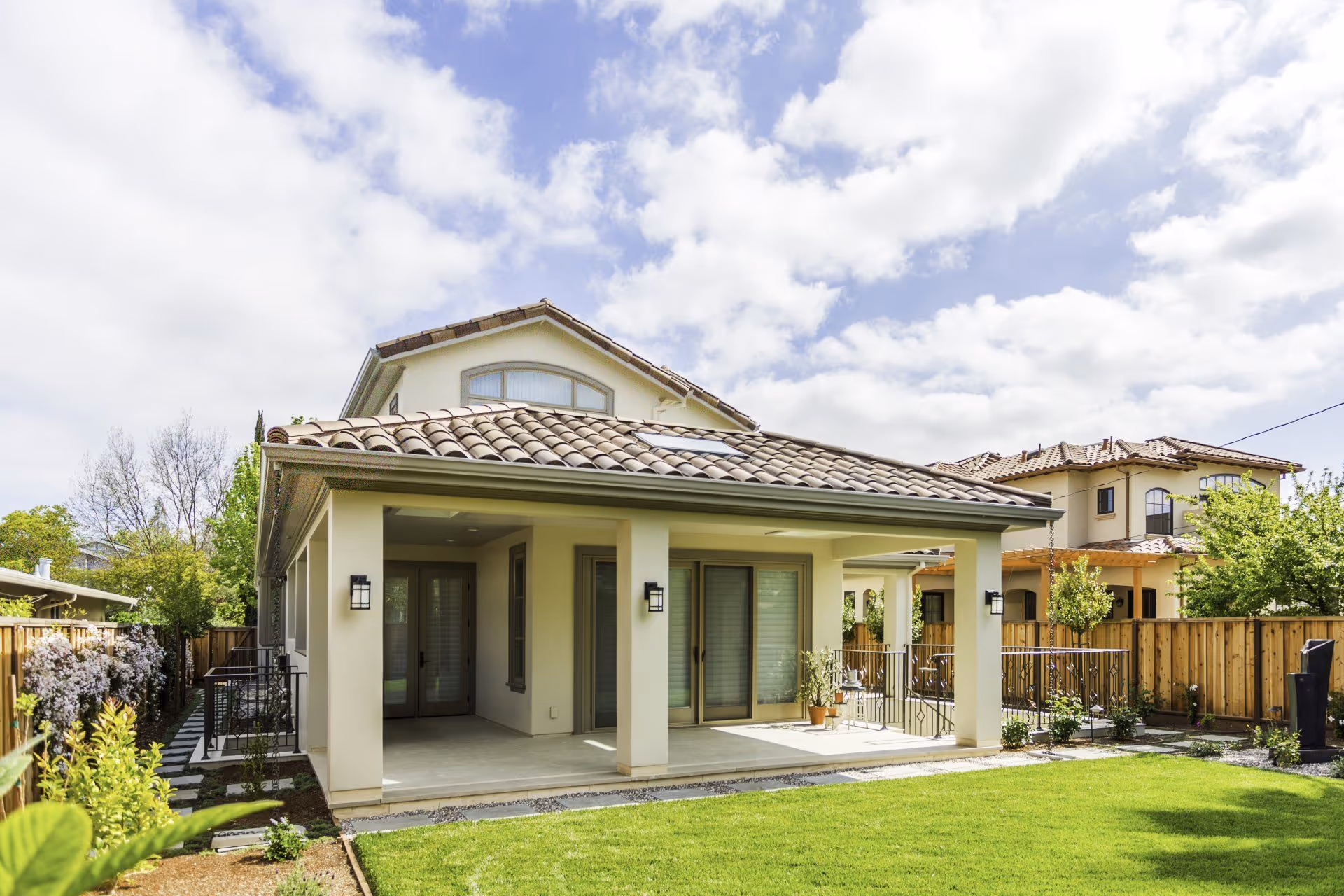 spanish style home with clay shingle roof and stucco siding