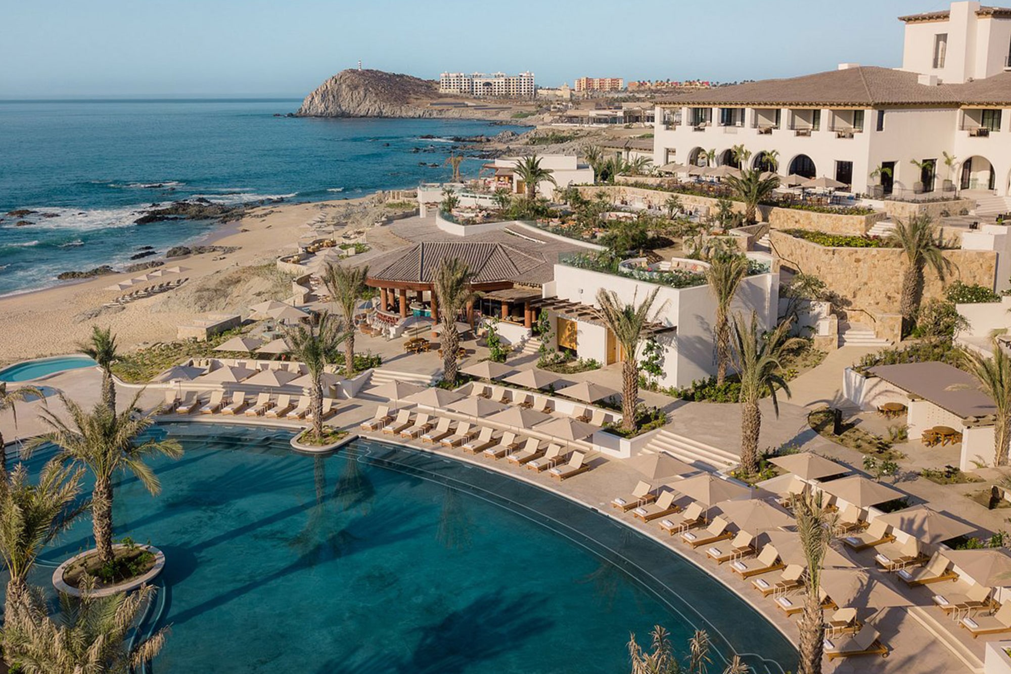Aerial view of oceanfront resort with pool and beach at Four Seasons Cabo del Sol, represented by Terentti