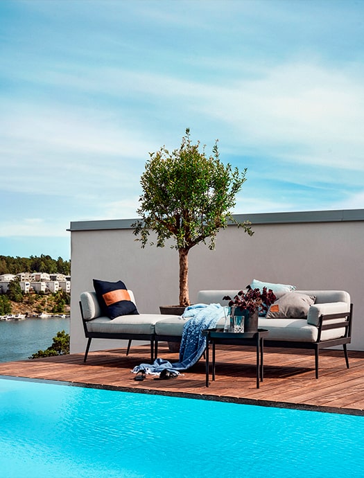Skargaarden outdoor lounge sofa by Terentti placed by the pool with scenic view