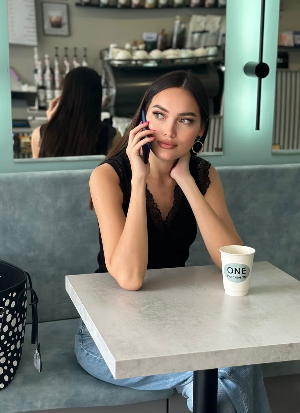 An OnlyFans model chats on the phone to her OnlyFans Agency manager
