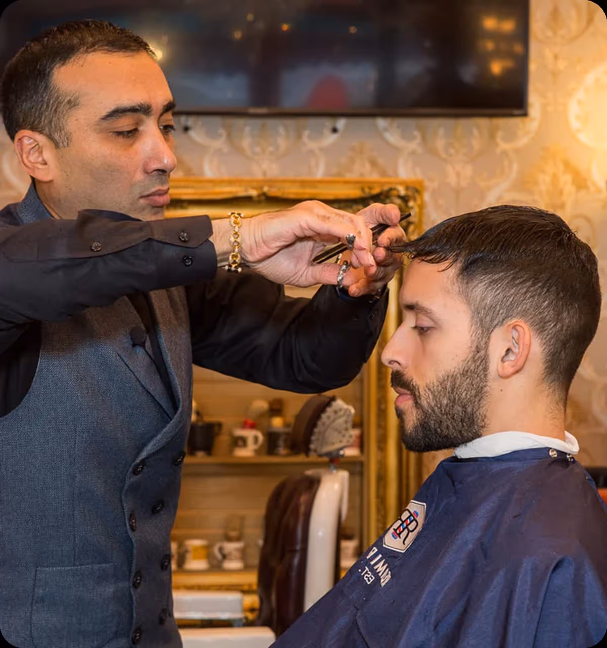 Barber performing a precise haircut for a client inside a classic barbershop with vintage decor