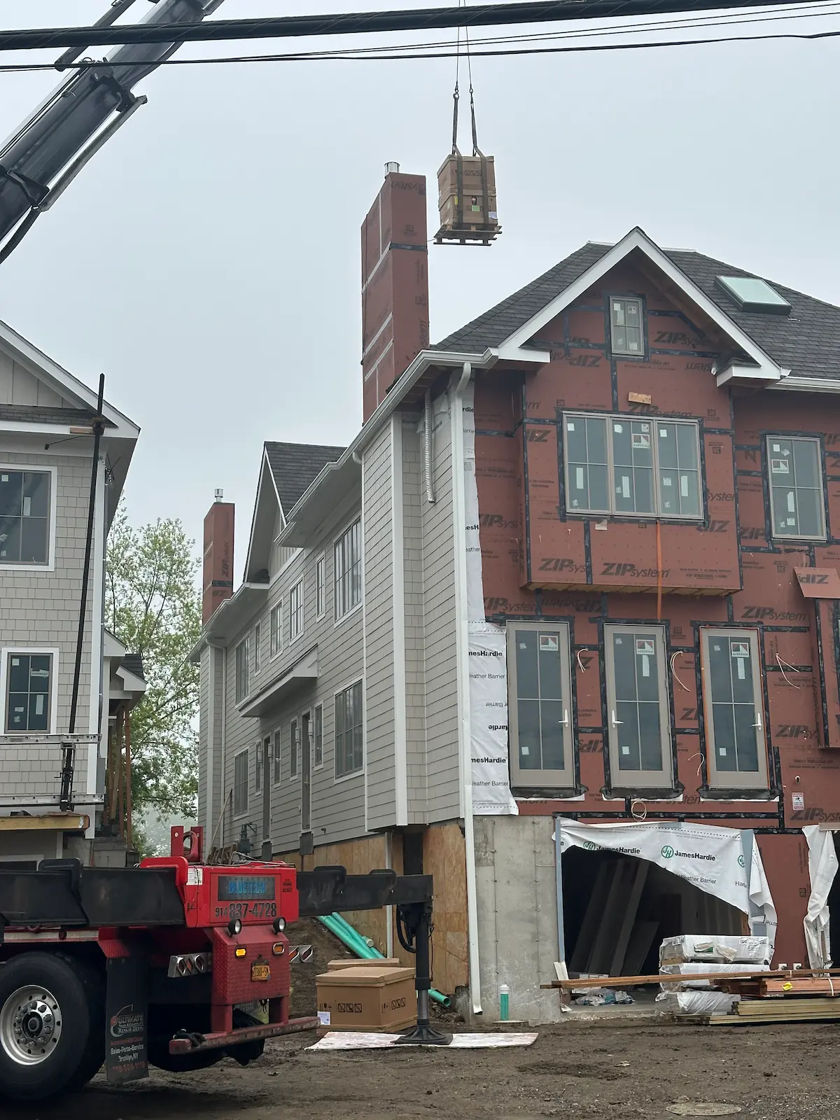 Close-up of HVAC equipment hoisted to rooftop of duplex under construction in Greenwich, CT