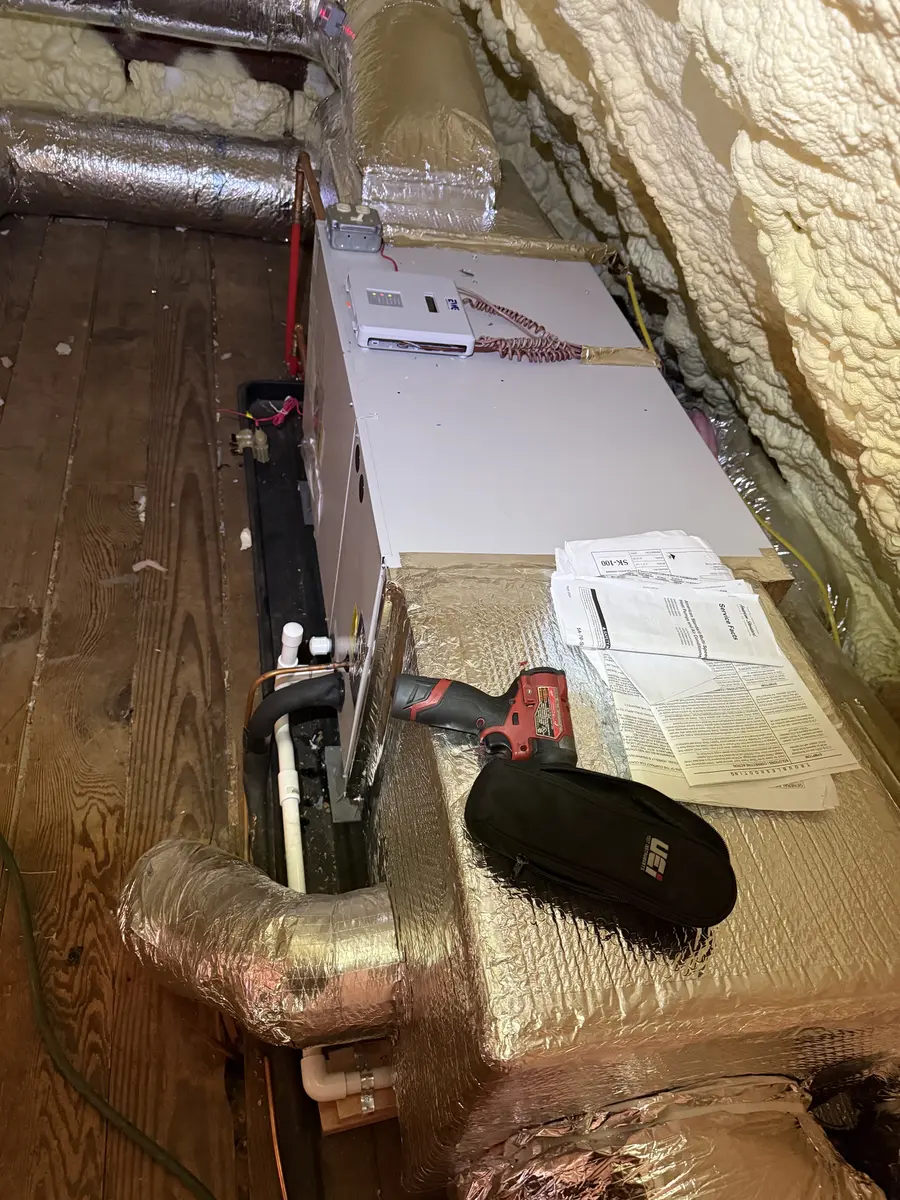 Residential air handler, refrigerant piping, and drain connections in a Hastings-on-Hudson mechanical room
