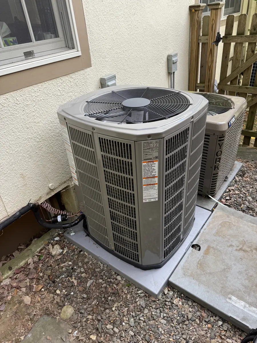 Two outdoor condenser units serving a residential HVAC system in Hastings-on-Hudson, NY