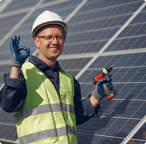 An engineer on a roof carrying out solar panels maintenance. 