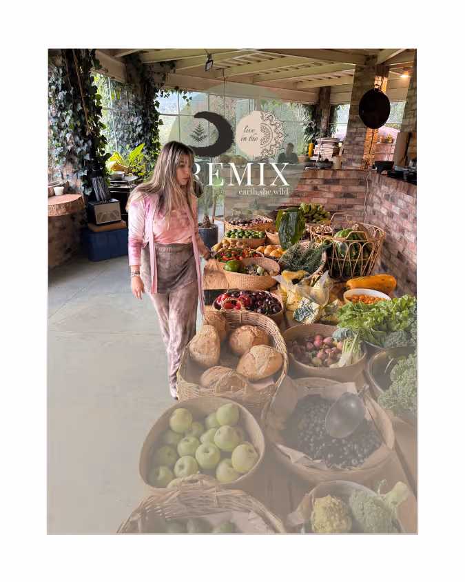 Woman in casual clothes shopping at an indoor market with baskets of fresh vegetables, fruits, and breads on a wooden table.