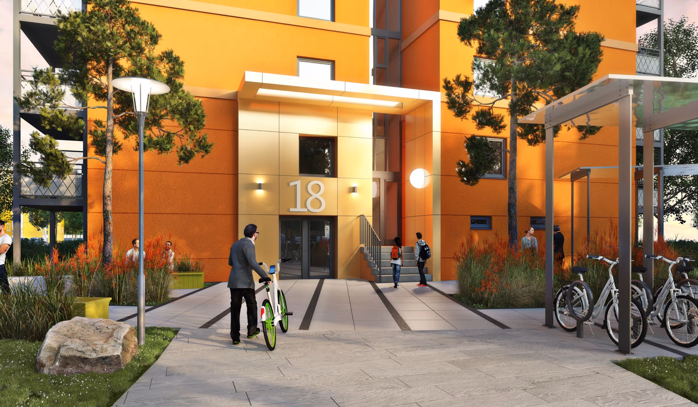 Person mit Fahrrad läuft auf den Eingang eines orangefarbenen Gebäudes mit der Nummer 18 zu, umgeben von Bäumen, Pflanzen und weiteren Personen.