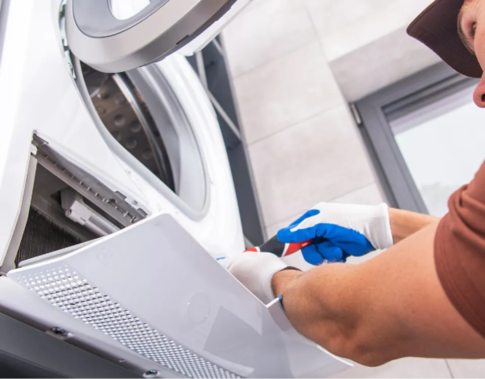 Technician repairing a dryer