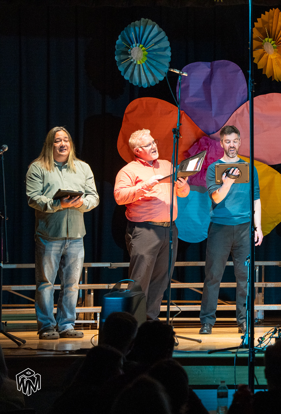 Men’s choir performing on stage during a live concert