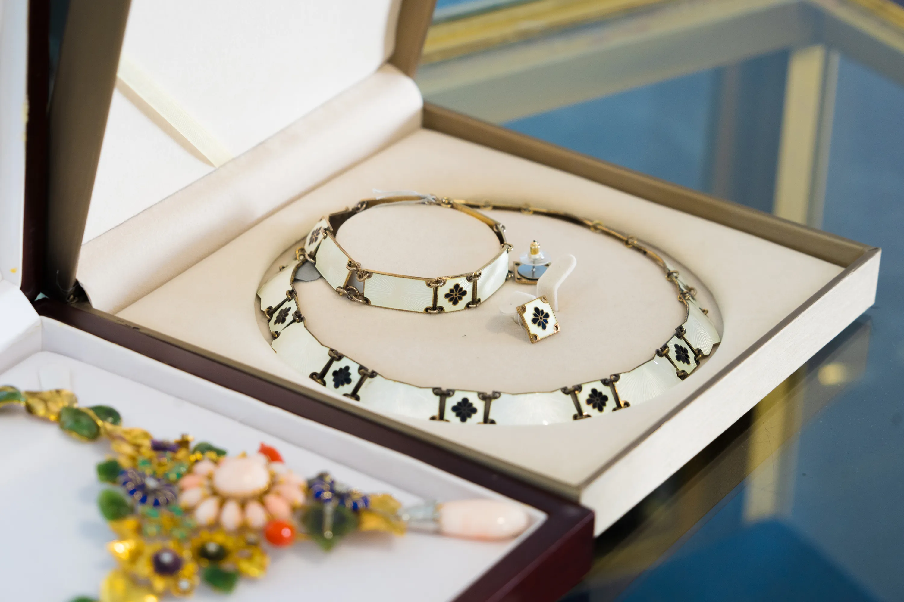 Statement necklace and bracelet with geometric pattern displayed in jewelry presentation box