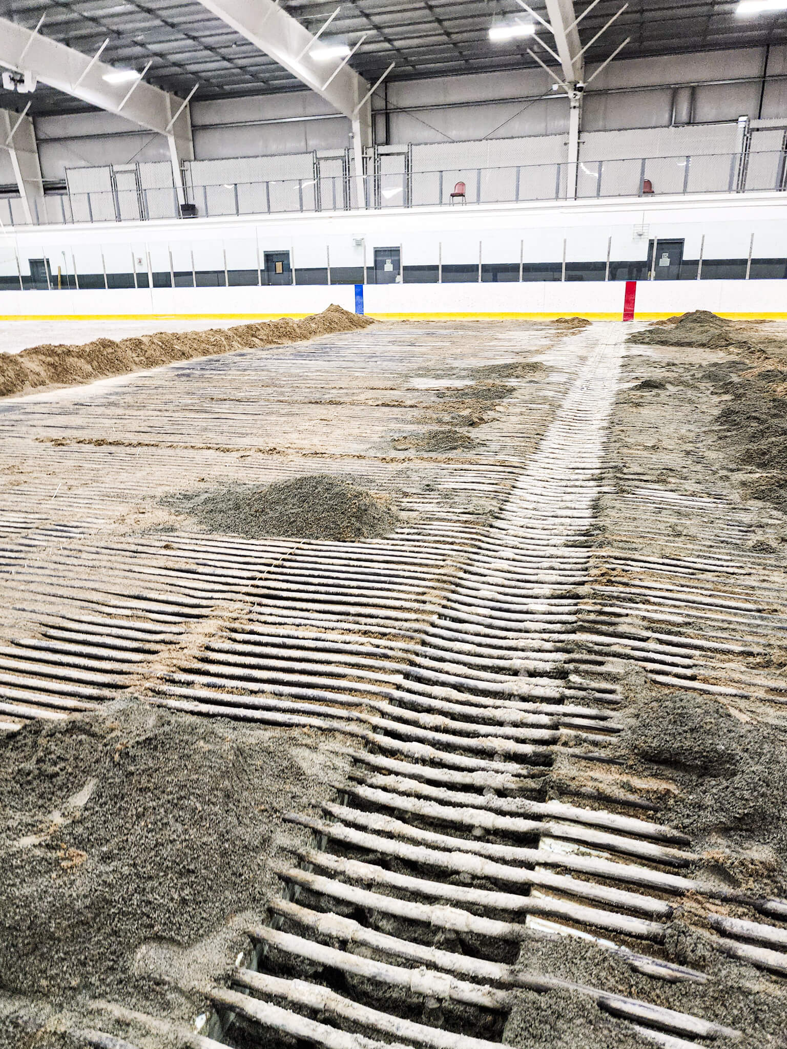 Technician servicing ice rink refrigeration system at a South Shore Massachusetts arena