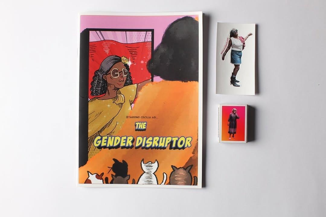 A picture of a few merchandise items created in Cecilia’s theme – (clockwise) zine, stickers, and a matchbox