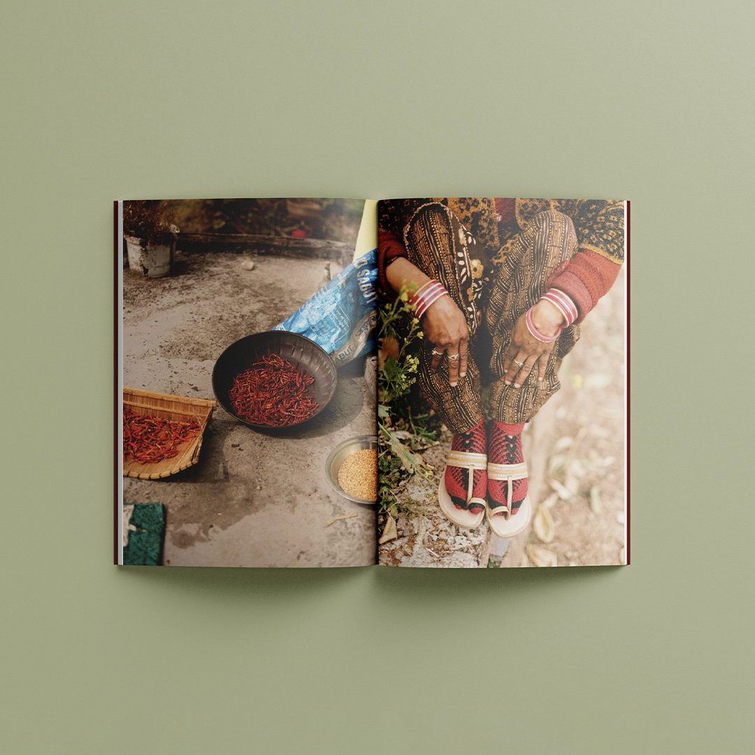 Image of two pages inside the photobook. Left side: chillies being dried. Right side: a woman’s hands and feet.