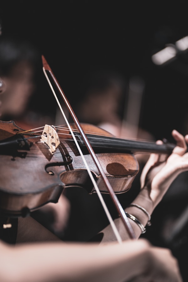 a close up of a person playing a violin