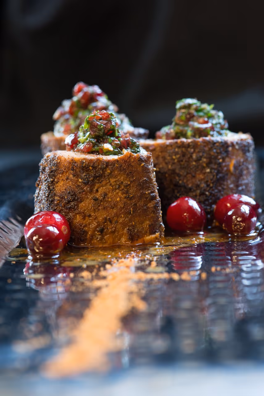 Seared pork appetizer with herbs and cranberries by Exquisite Delites, Atlanta.